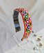 Festive Navratri headband with vibrant embroidered geometric patterns in pink, yellow, green, and blue, displayed on a clear stand.
